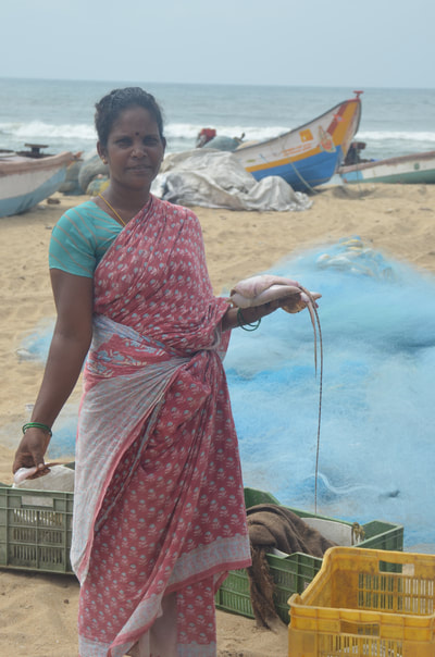 A woman selling skinned sting rays