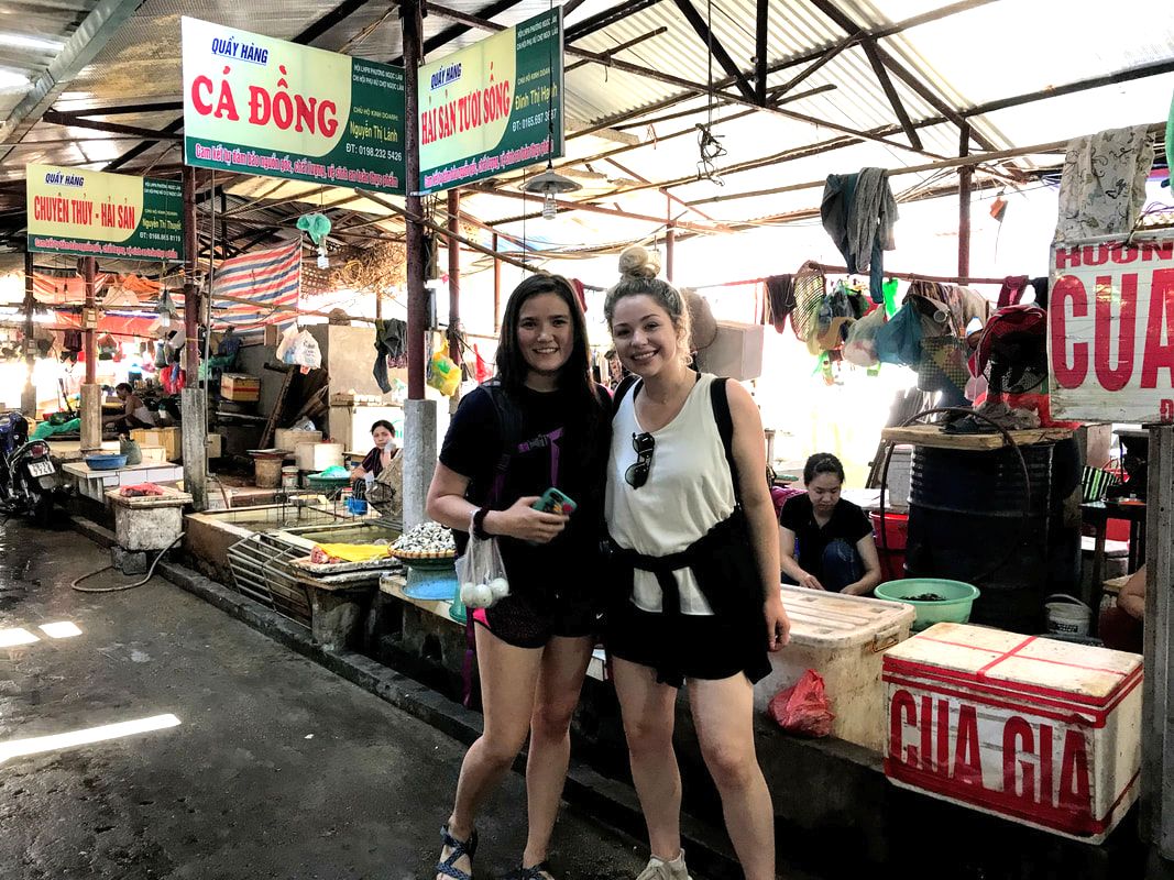 2 Students in the marketplace in Hanoi