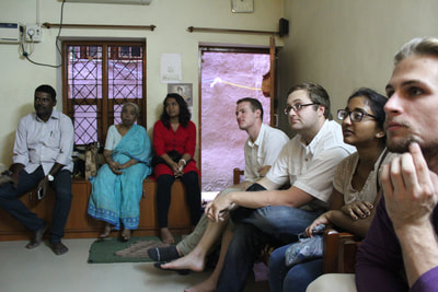 Students meet with local family in their home, 2015