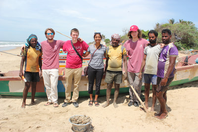 The team poses with local fishers after interviewing them for feedback on their innovation.