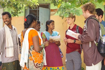 Students talking to local women