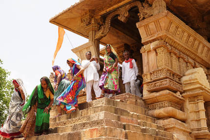 Religious pilgrims descending the steps of a temple in Khajuraho