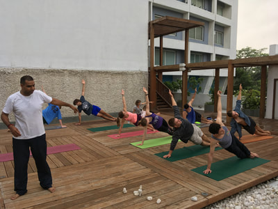 Students take an evening yoga class on the roof