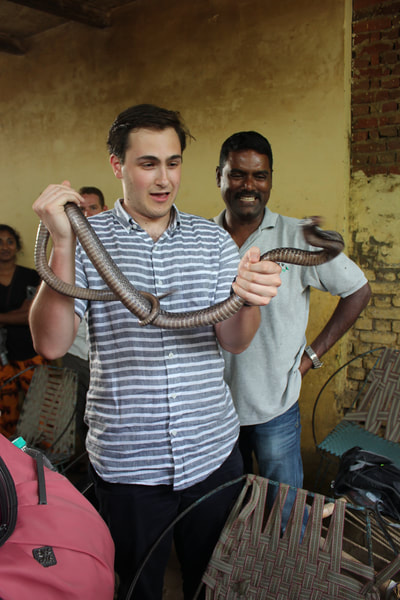 Student holds a cobra, 2015